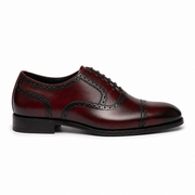 Side profile of a burgundy leather brogue Oxford shoe for men