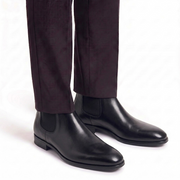 Black Chelsea boots worn with formal trousers