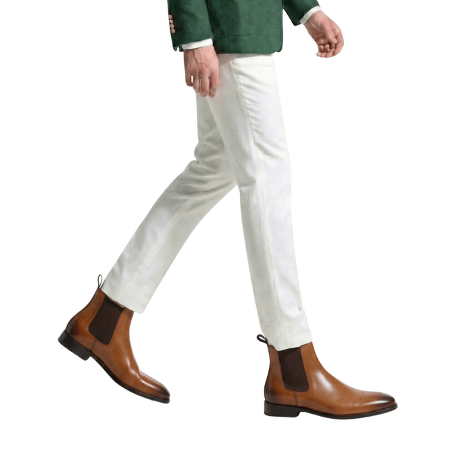 Brown Chelsea boots with light trousers men's smart casual outfit walking pose