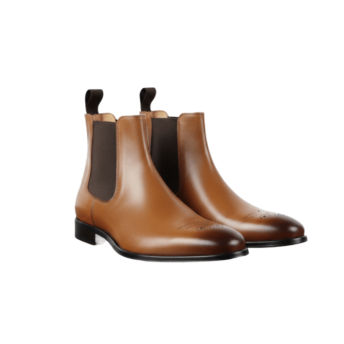Tan leather Chelsea boots for men with brogue detailing, ideal for styling with black jeans.