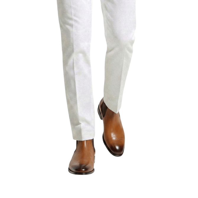 Front view of brown leather Chelsea boots with light slim fit trousers