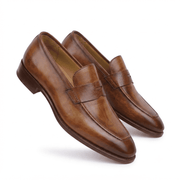 Pair of brown leather penny loafers in angled view