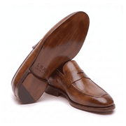 Angled view of brown leather penny loafers showing upper design