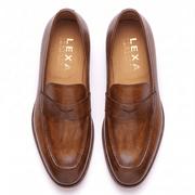 Top view of brown leather loafers showing polished leather finish