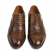 Front angled view of handcrafted brown brogue Derby shoes