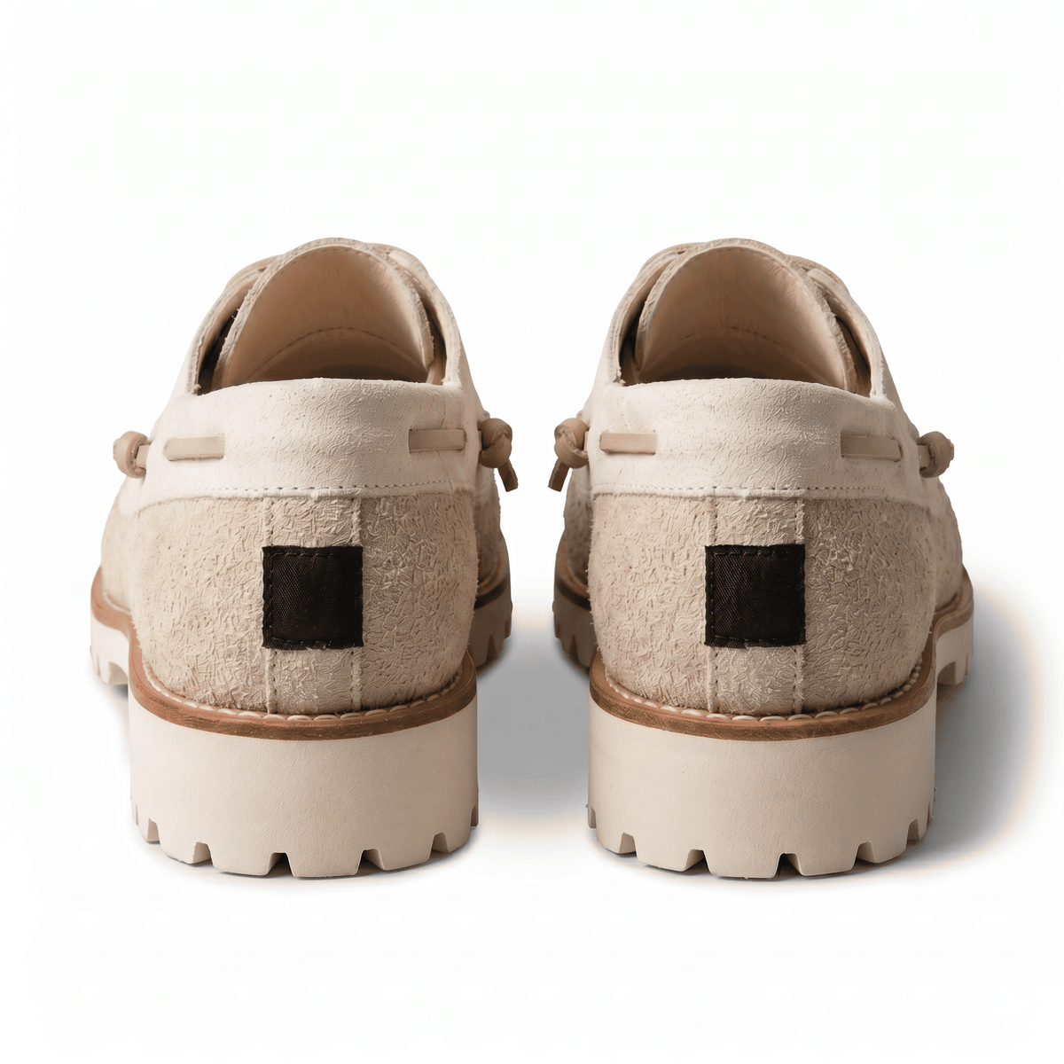 Back view of the shoes showing the leather lace wrap-around detail and the heavy-duty off-white rubber heel.