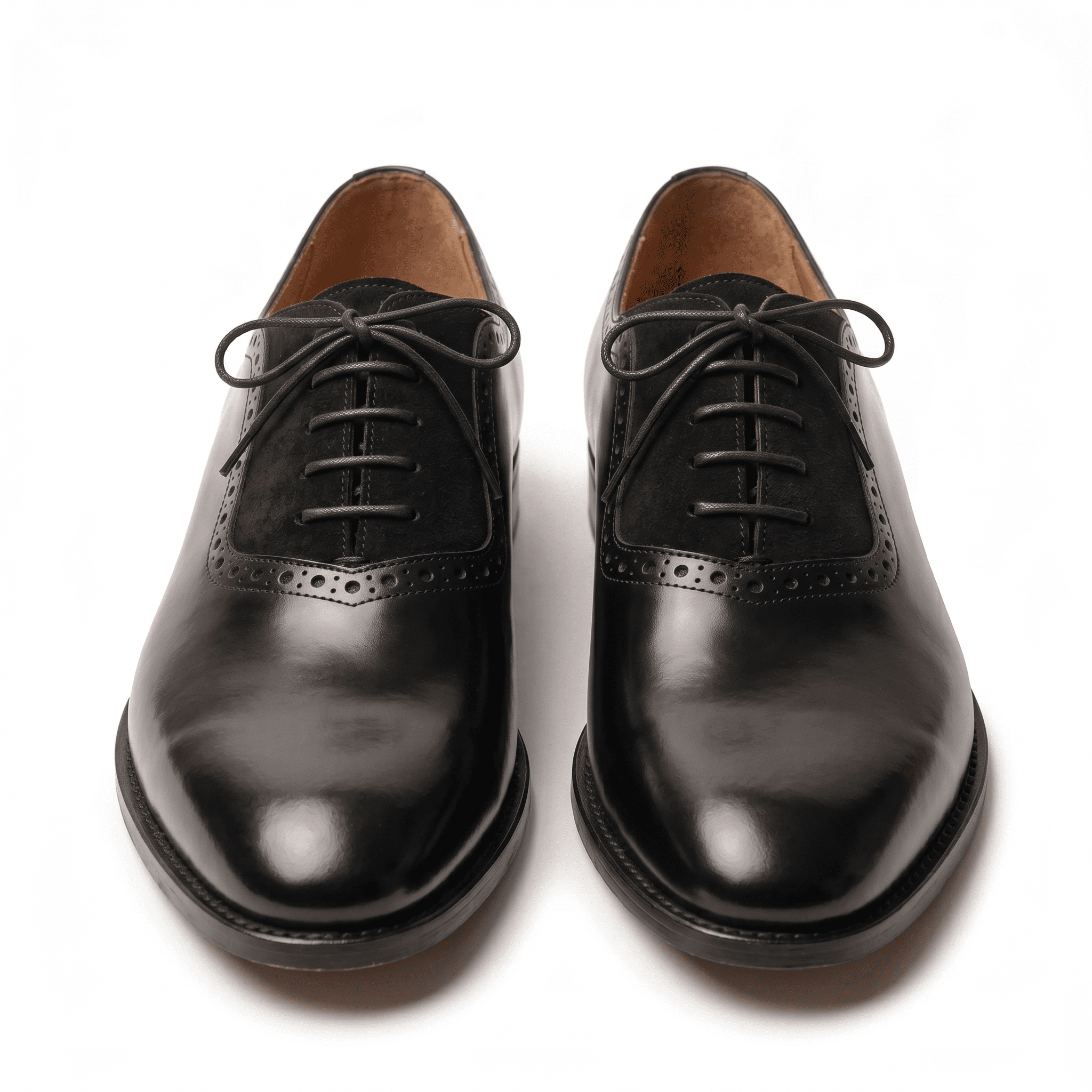 Front-facing view of the pair highlighting the symmetrical lacing system and the high-shine finish on the toes.