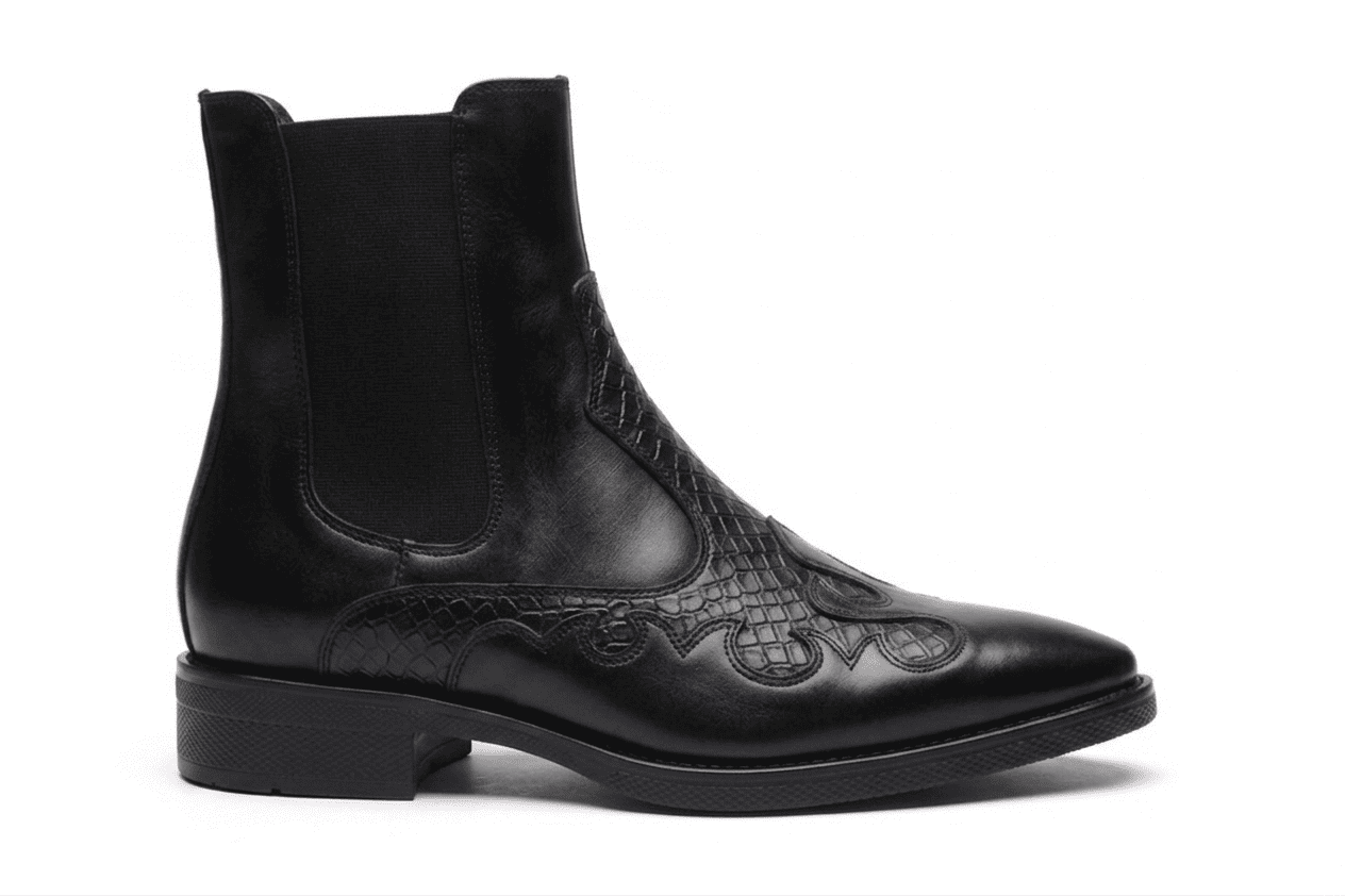 Clean side profile of the black leather boot highlighting the elastic side gusset and the decorative stitching pattern.