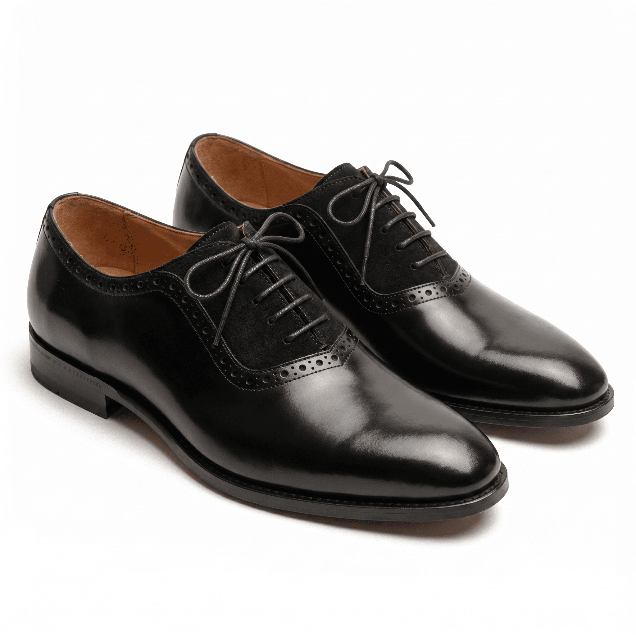 A pair of luxury black leather Oxford shoes featuring a unique suede mid-panel and classic brogue detailing.