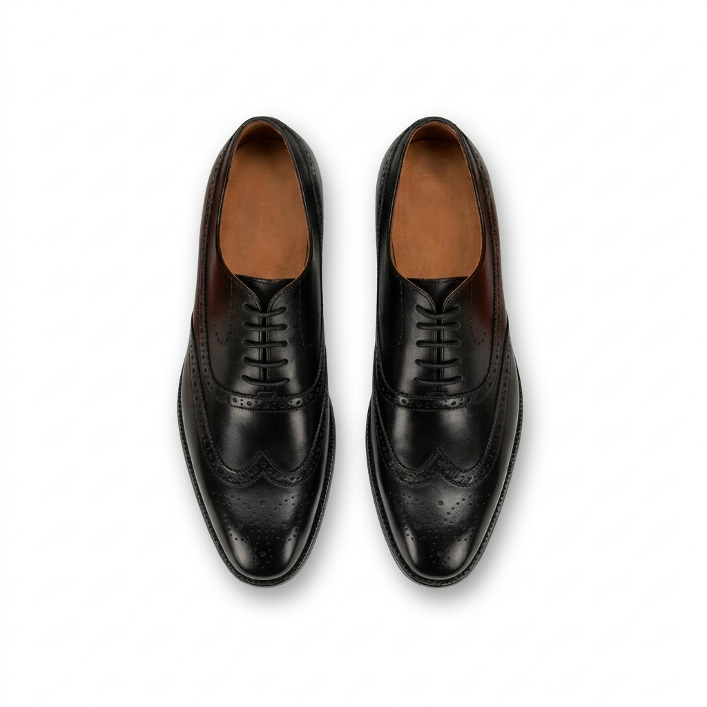 Top view of black leather wingtip oxford shoes for men with brogue detailing formal footwear