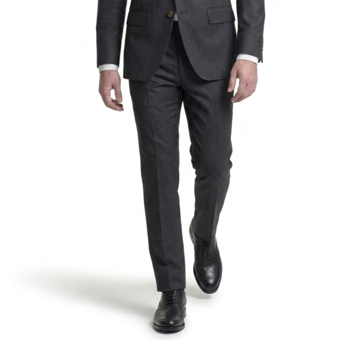 Front view of man walking in grey suit wearing classic black leather oxford dress shoes