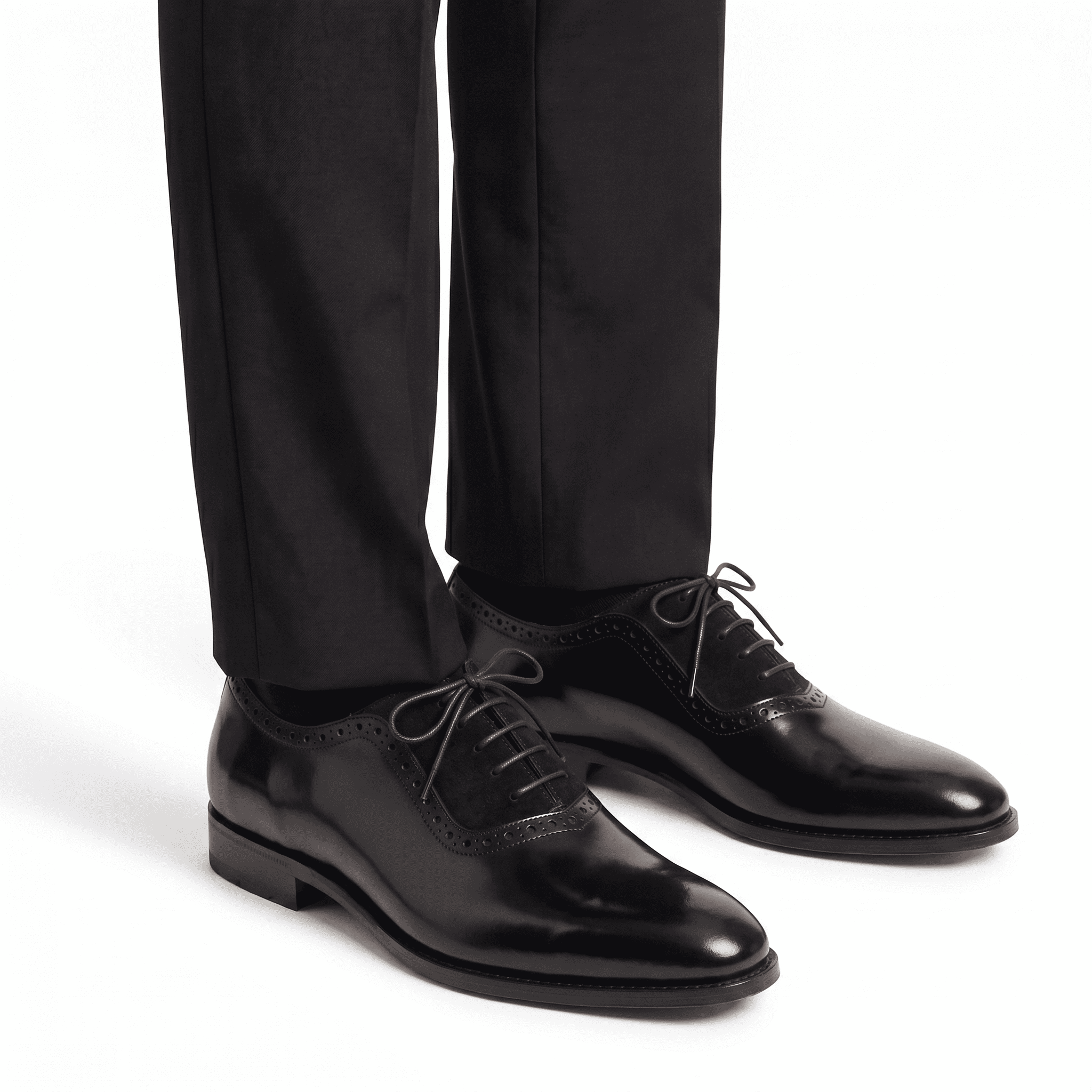The black leather and suede Oxfords styled with black tailored trousers for a professional formal look.