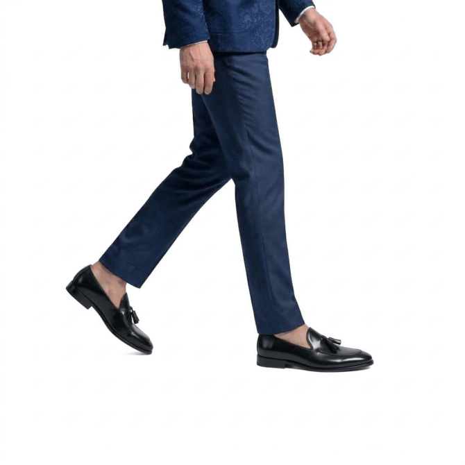 man walking wearing black tassel loafers formal outfit