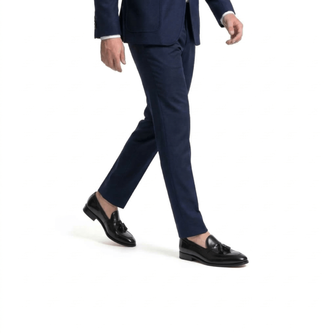 man walking wearing black tassel loafers formal outfit