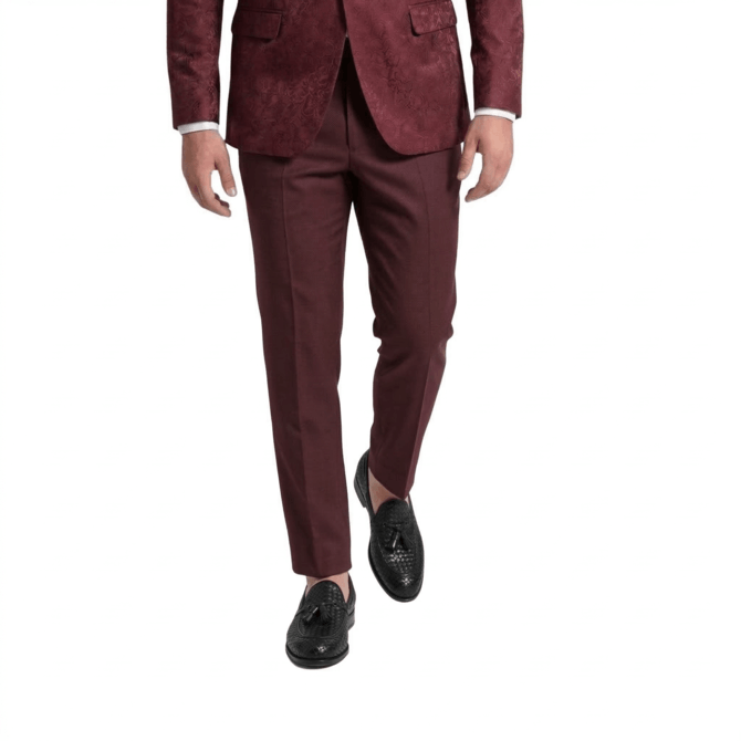 Rear styling view of luxury black woven tassel loafers with slim-fit maroon suit pants
