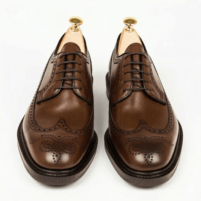 Front view of brown polished brogue Oxford shoes for men