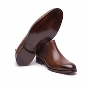Bottom sole view of brown leather Chelsea boots for men showcasing the durable outsole and quality craftsmanship.