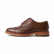 Side view of brown leather wingtip oxford shoes for men with brogue detailing formal footwear