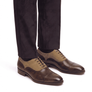 Men's brown and tan Oxford leather shoes paired with formal trousers for business attire