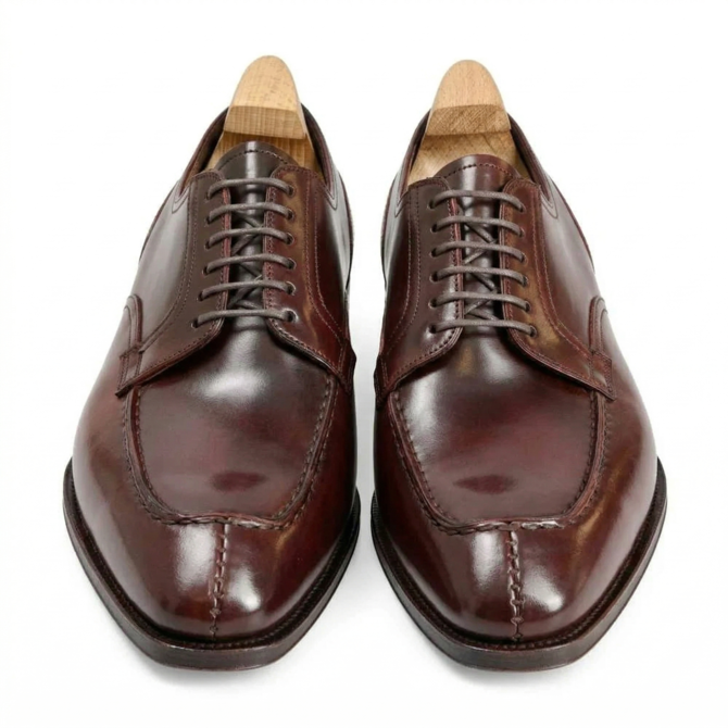 Front view of burgundy polished Oxford shoes for men