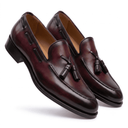 Angled side view of mens burgundy leather tassel loafers