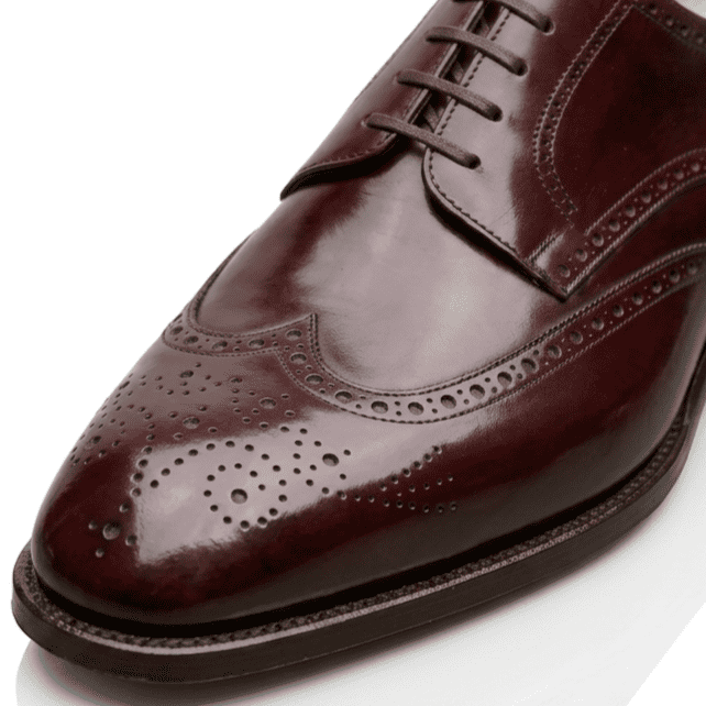 Close-up front detail of Burgundy wingtip brogue leather shoes