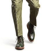 Professional lifestyle shot of the forest green boots worn with olive green trousers for a monochromatic look.