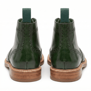 Back view of the forest green boots highlighting the sturdy heel construction and stacked leather sole.