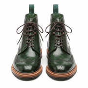 Front-facing view of the pair highlighting the round toe cap and the contrast between the green leather and brown laces.