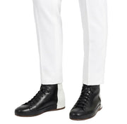 men wearing black leather boots with white pants stylish look
