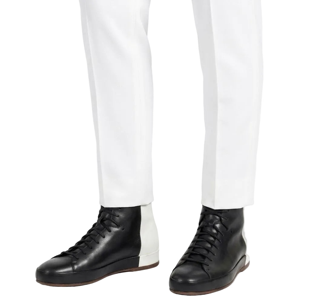 men wearing black leather boots with white pants stylish look