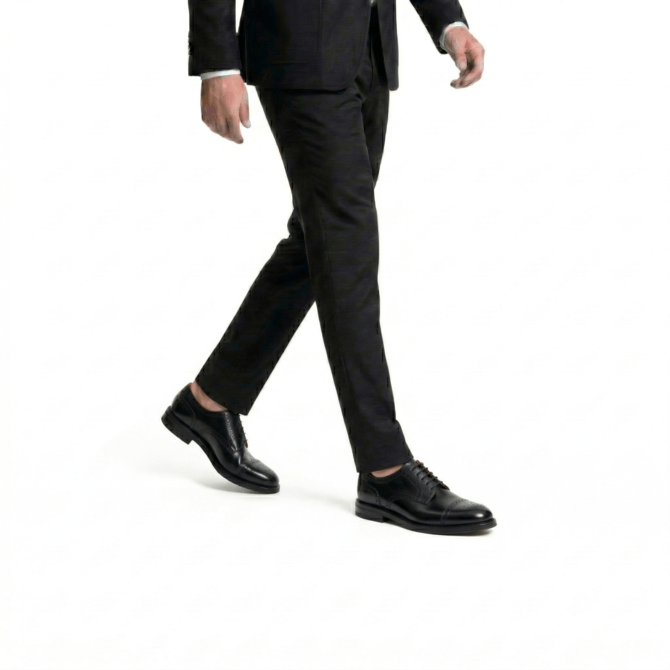 Action view of luxury black leather oxford shoes for men, featuring a refined silhouette and traditional decorative broguing.