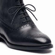 Close-up detail of Midnight Navy Leather Brogue Boots stitching and laces