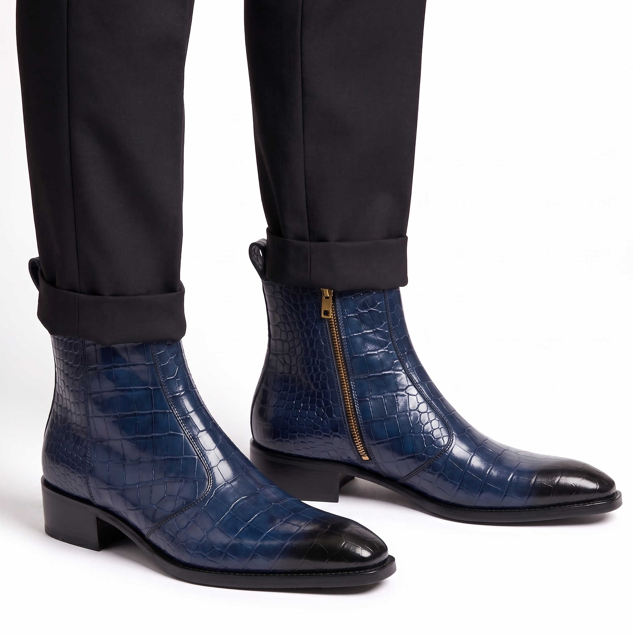 Close-up of navy blue crocodile-textured boots worn with black tailored trousers for a formal look.