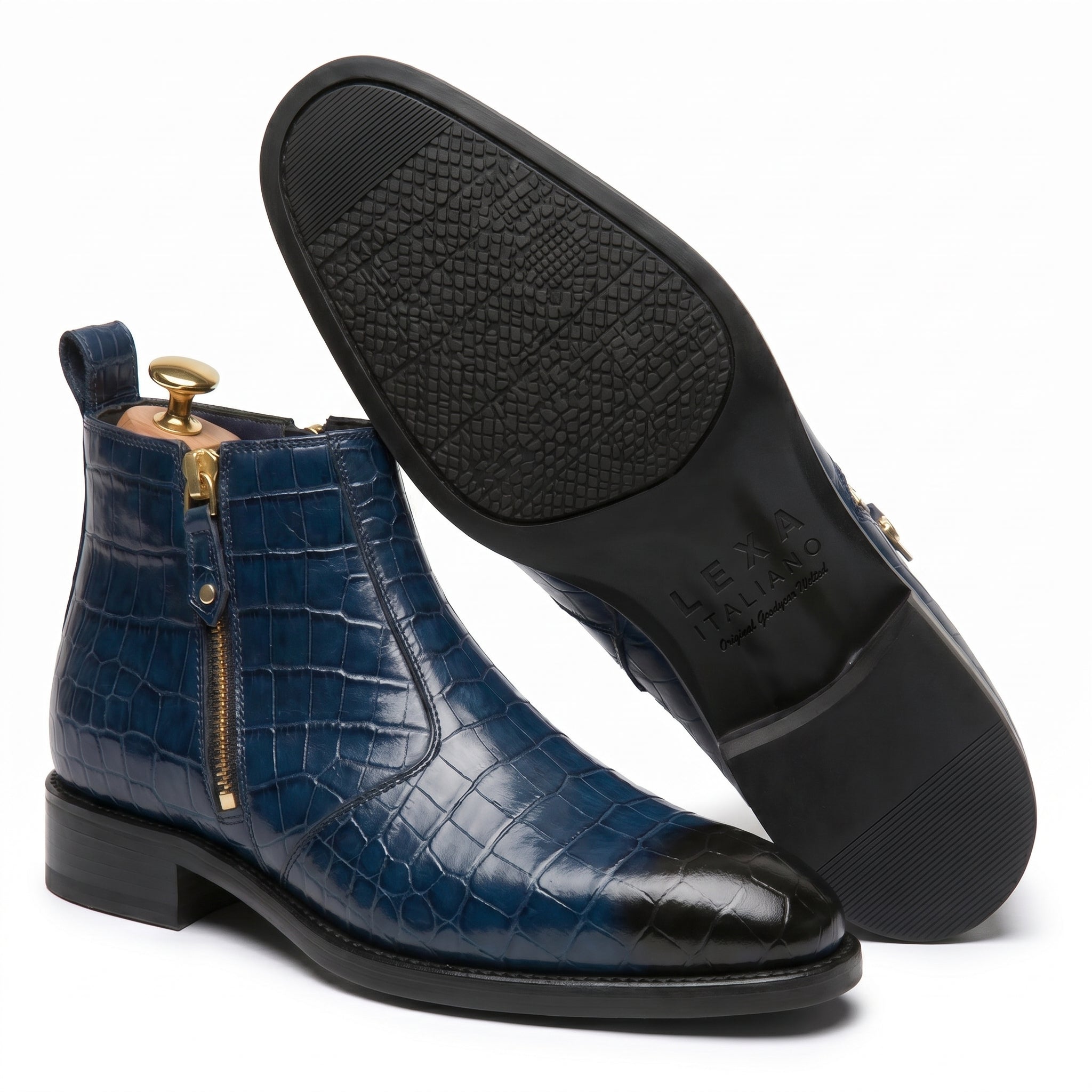 Angled view of the boot showing the textured black outsole and the side brass zipper hardware.
