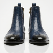Front-facing shot of navy blue leather boots highlighting the black gradient cap toe and symmetrical design.