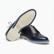 Angled view of the shoe showing the light-colored outsole and the blue accent layer of the midsole.