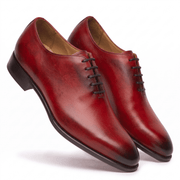 Angled view of premium red hand-painted cap-toe Oxford shoes for men showcasing elegant craftsmanship