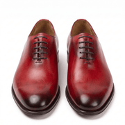 Front view of red leather cap-toe Oxford shoes for men featuring a polished toe and classic lace-up design.