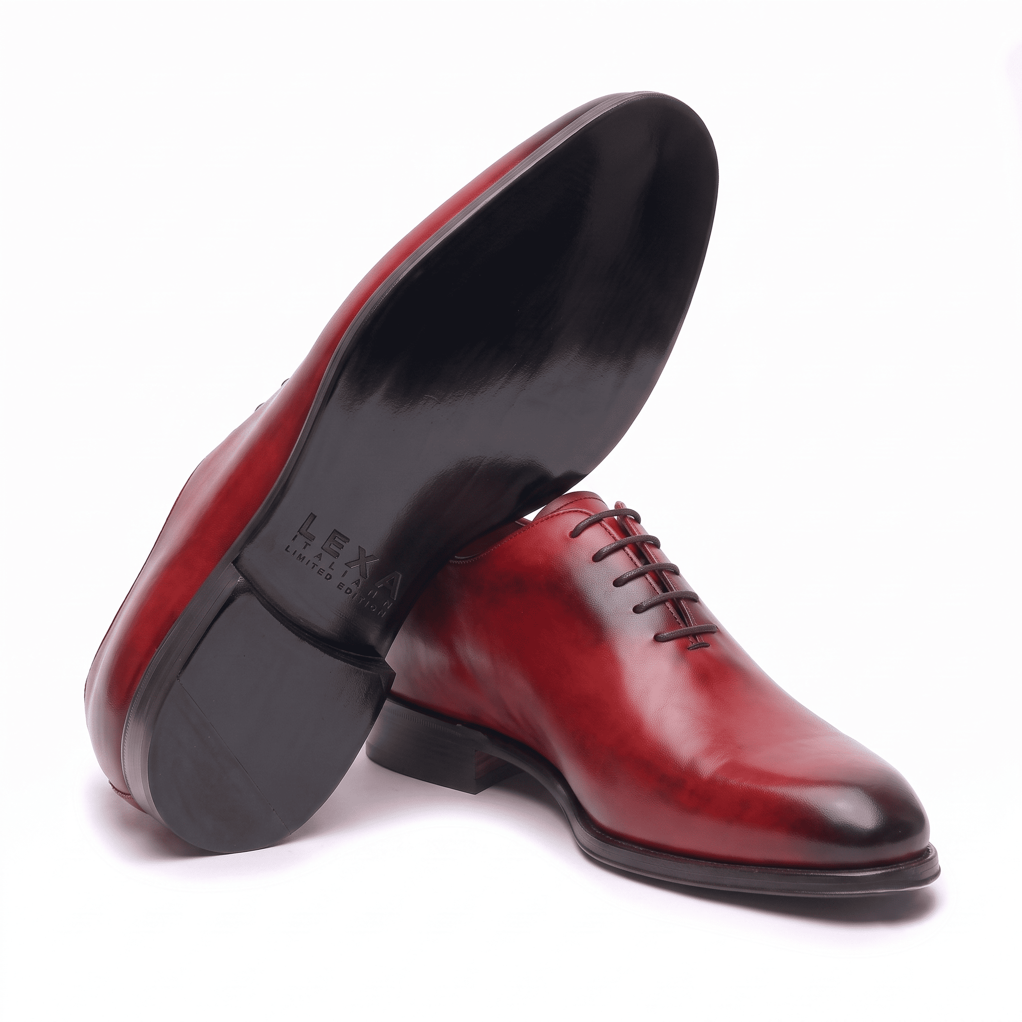 Bottom sole view of premium red leather cap-toe Oxford shoes for men highlighting the durable outsole.