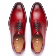 Top view of red hand-painted leather Oxford dress shoes for men showing the lace-up closure and premium craftsmanship.