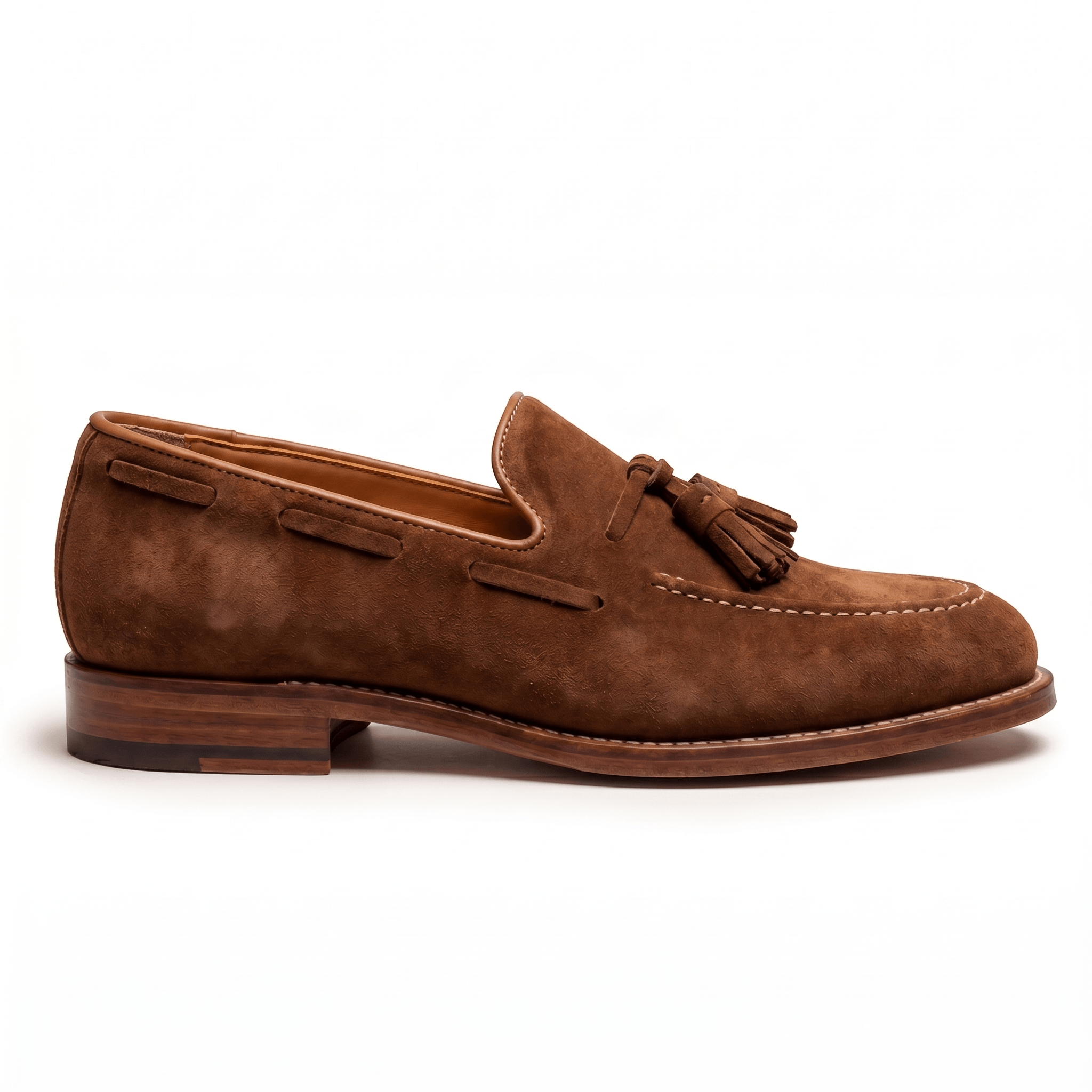 Side silhouette of tan suede tassel loafers for men