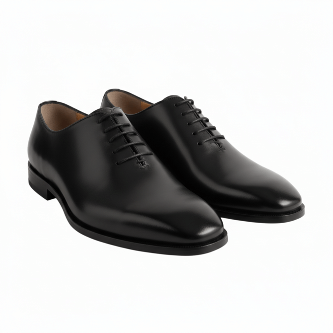Three-quarter view of luxury black leather wholecut Oxford shoes for men.