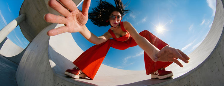 Woman wearing premium comfort red leather loafers with modern fashion styling in an outdoor urban setting